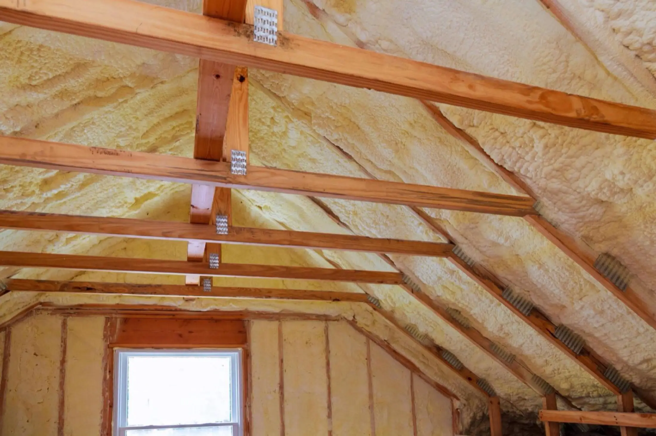 Spray foam being applied to a roof deck
