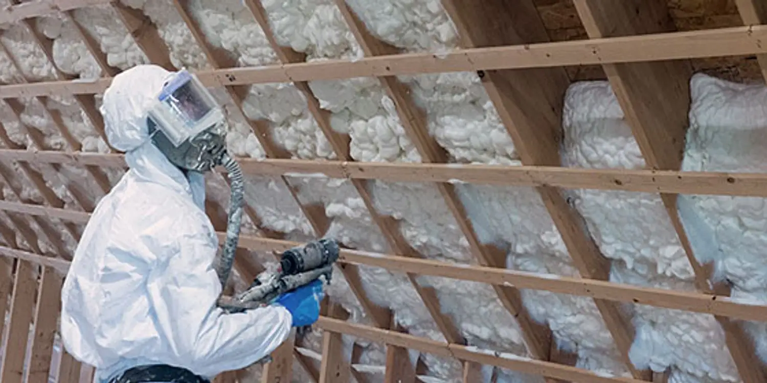 Metal building insulated with spray foam